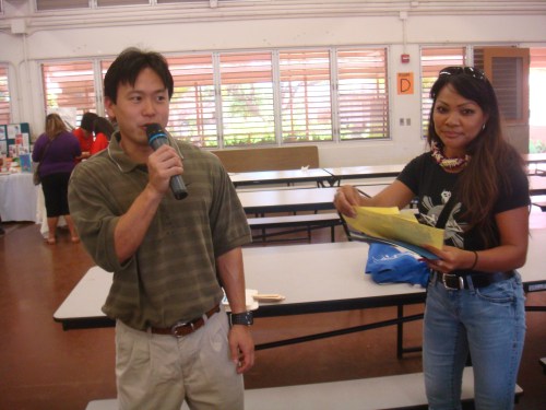 Rep. Jon Riki Karamatsu addressing the croww qith Betty Bartolome, DJ for Filipino Radio KPHI, 1130 AM/101.5/OC 882 FM